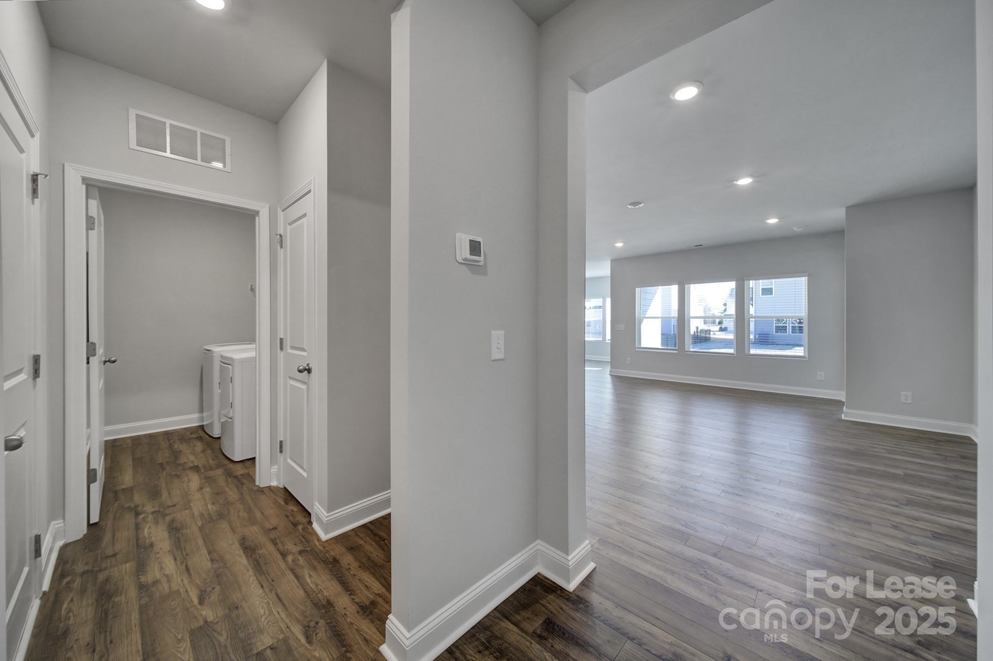 1112 Bradford Pear Road Monroe, NC 28112 - Photo 9 of 33 a view of a hallway with wooden floor and a living room
