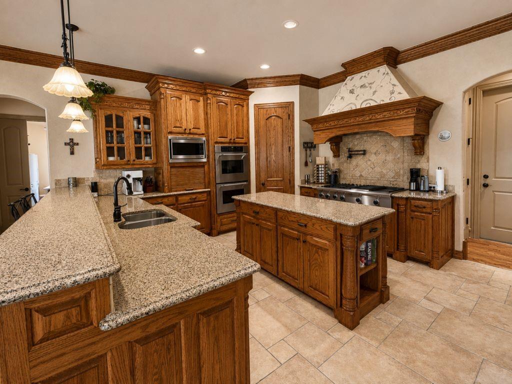 7005 Peter's Path Colleyville, TX 76034 - Photo 9 of 40 a kitchen with stainless steel appliances granite countertop a stove a sink and a microwave