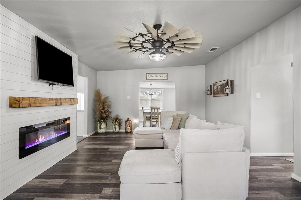 1216 VZ County Road Canton, TX 75103 - Photo 12 of 40 a living room with furniture a flat screen tv and a fireplace