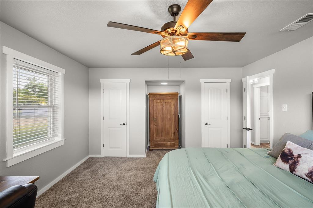 1216 VZ County Road Canton, TX 75103 - Photo 29 of 40 a bedroom with a bed and a chandelier