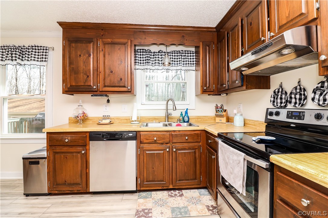 2210 Mill Road Powhatan, VA 23139 - Photo 11 of 36 a kitchen with stainless steel appliances granite countertop a stove a sink and a microwave