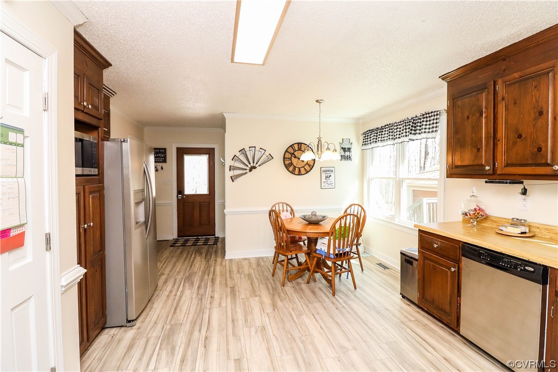 2210 Mill Road Powhatan, VA 23139 - Photo 12 of 36 a dining room with stainless steel appliances granite countertop furniture wooden floor and a window