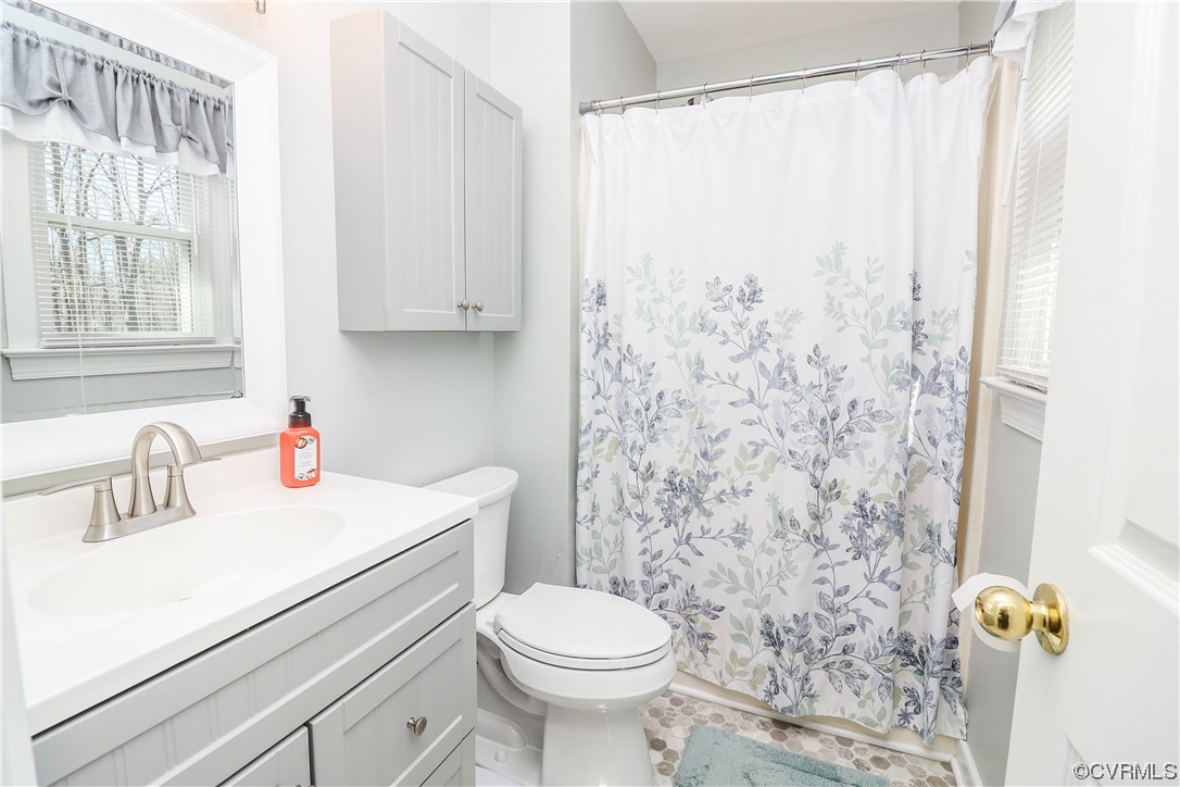 2210 Mill Road Powhatan, VA 23139 - Photo 16 of 36 a bathroom with a sink a toilet and shower curtain