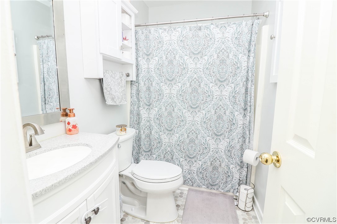 2210 Mill Road Powhatan, VA 23139 - Photo 18 of 36 a bathroom with a sink a toilet and shower curtain