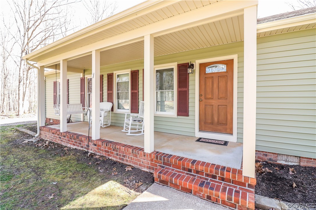 2210 Mill Road Powhatan, VA 23139 - Photo 2 of 36 a view of a house with wooden fence and a floor to ceiling window
