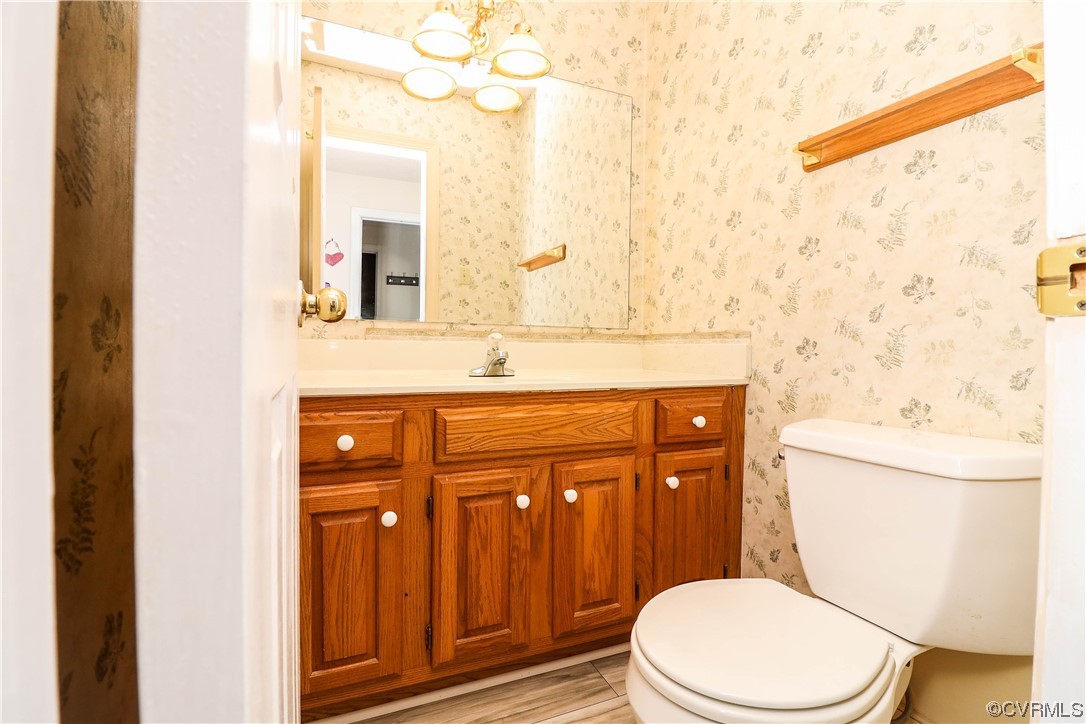 2210 Mill Road Powhatan, VA 23139 - Photo 22 of 36 a bathroom with a granite countertop toilet sink and mirror