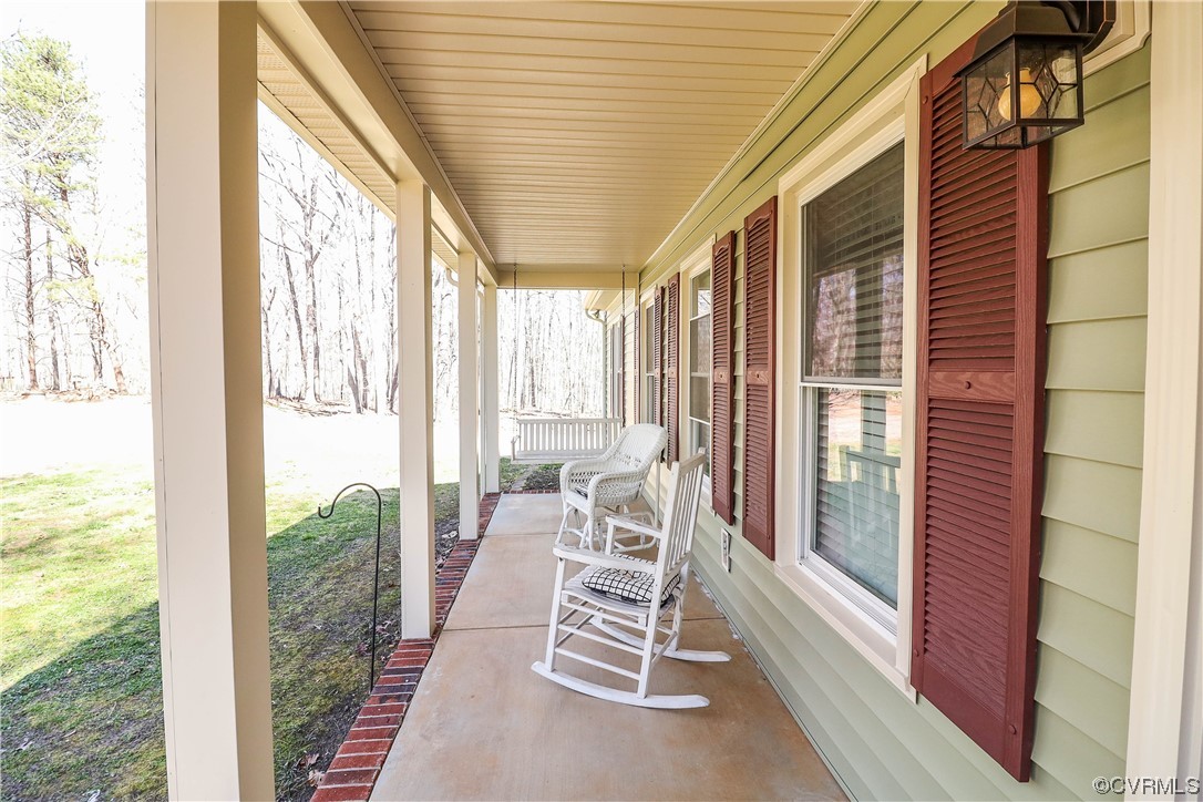 2210 Mill Road Powhatan, VA 23139 - Photo 3 of 36 a balcony with furniture and floor to ceiling window