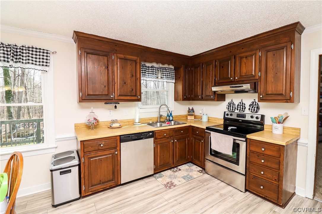2210 Mill Road Powhatan, VA 23139 - Photo 9 of 36 a kitchen with granite countertop wooden cabinets stainless steel appliances a sink and a window