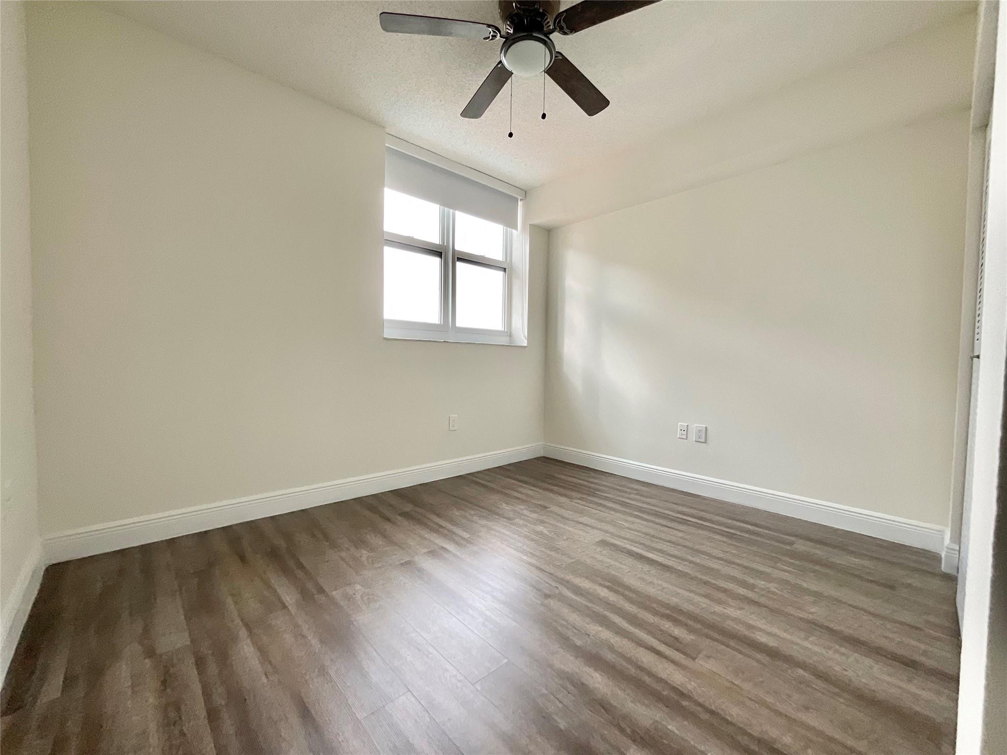 16900 North Bay Road, Unit 21211 Sunny Isles Beach, FL 33160 - Photo 4 of 30 wooden floor in an empty room with a window