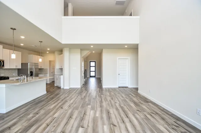 a view of a large kitchen with wooden floor and a sink