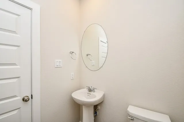 a bathroom with a sink a mirror and a toilet