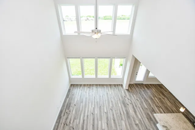 an empty room with windows and closet