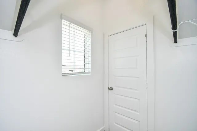 an empty room with closet area