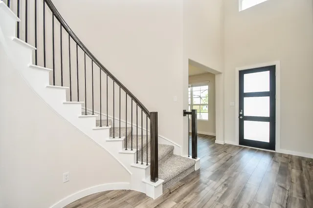 a view of an entryway with wooden floor and stairs
