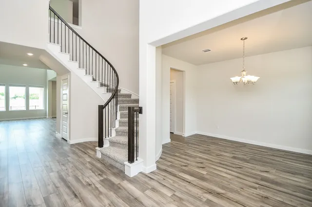 a view of a room with wooden floor and staircase