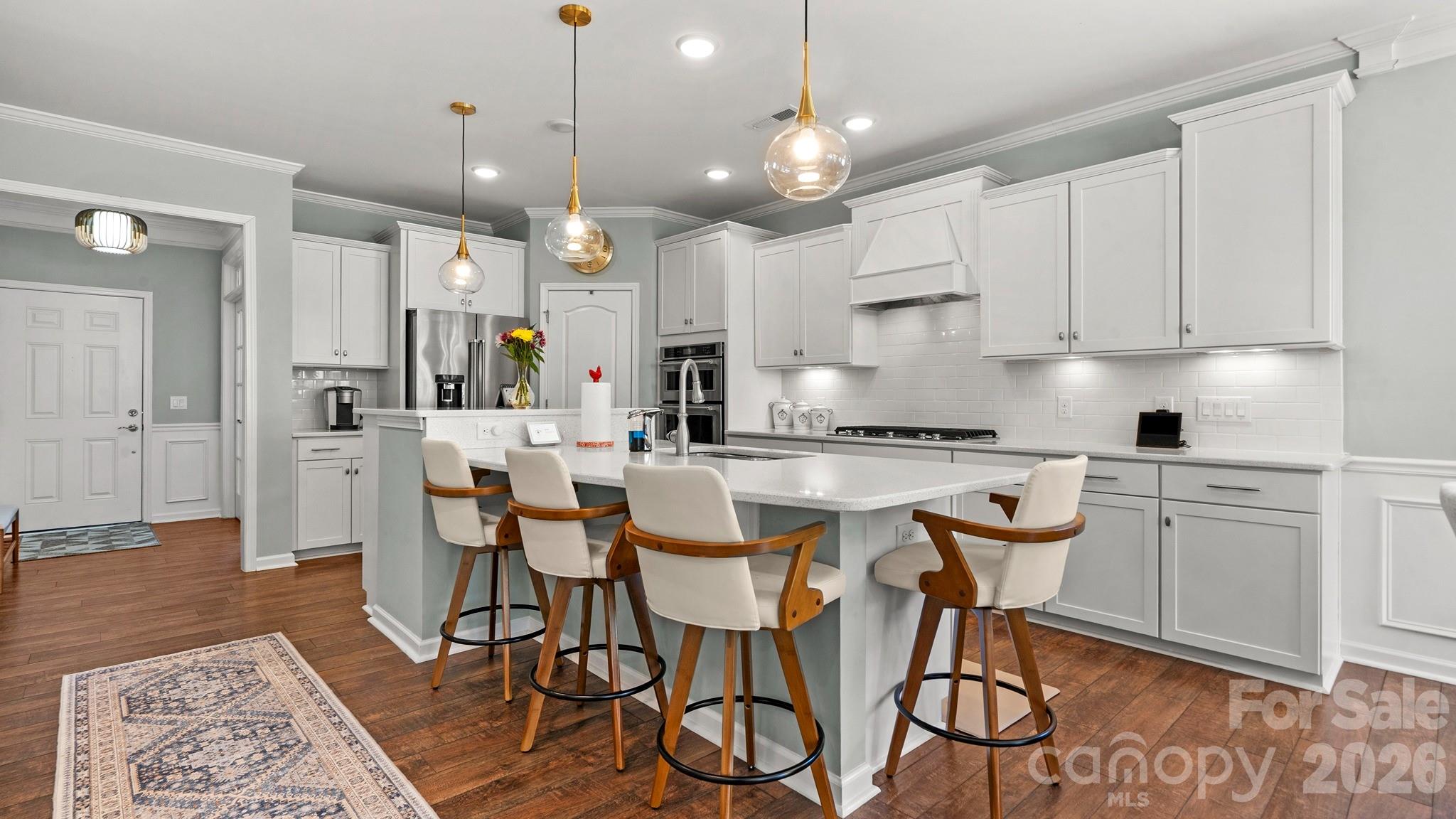 952 Kirby Drive Fort Mill, SC 29715 - Photo 14 of 42 a kitchen with stainless steel appliances granite countertop a sink a stove a refrigerator cabinets and chairs