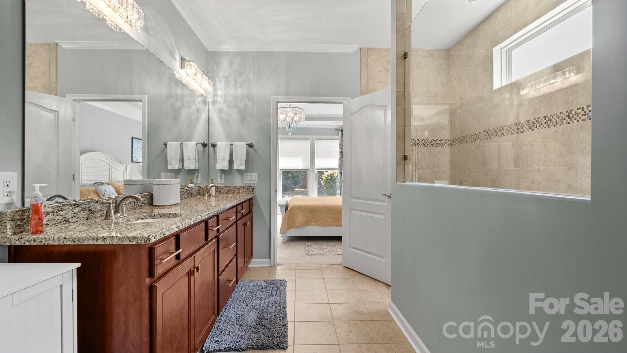 952 Kirby Drive Fort Mill, SC 29715 - Photo 18 of 42 a bathroom with a granite countertop sink a mirror and a bath tub