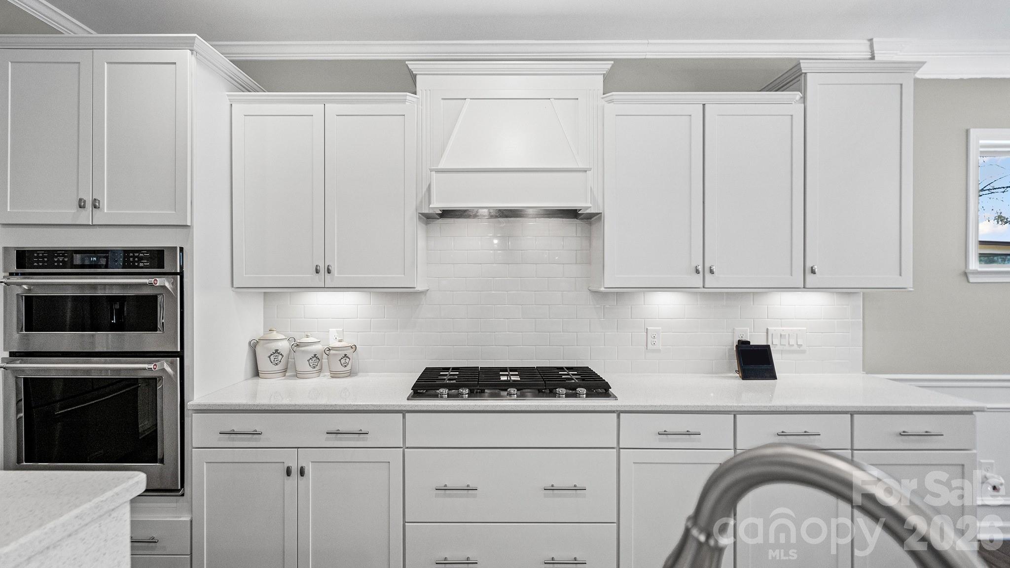 952 Kirby Drive Fort Mill, SC 29715 - Photo 10 of 42 a kitchen with white cabinets and stainless steel appliances