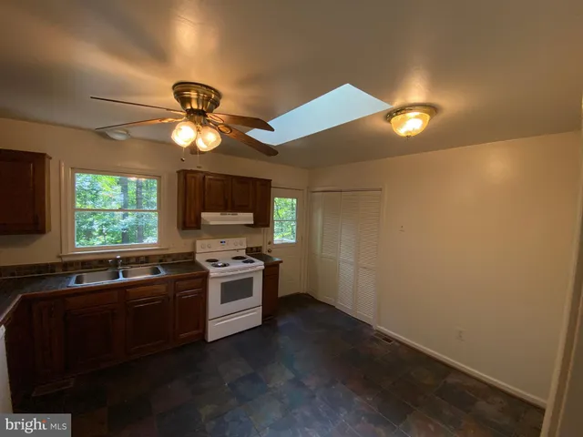 a kitchen with a sink and a stove top oven