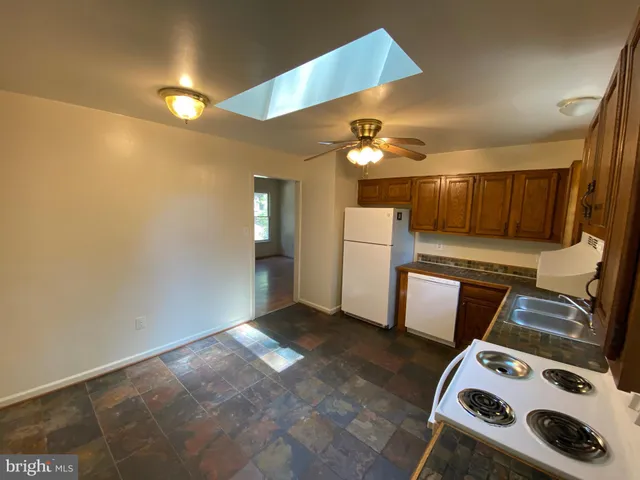 a view of a storage & utility room with two washing machine