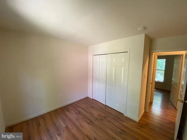 a view of a room with wooden floor