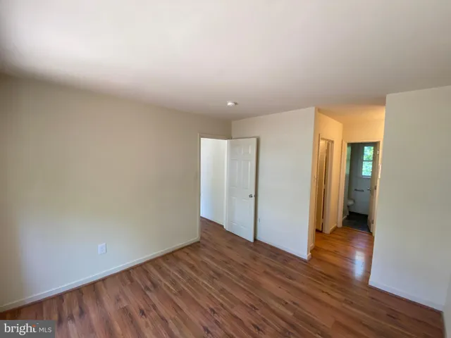 a view of an empty room and wooden floor