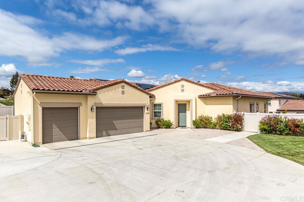a view of a white house with a yard