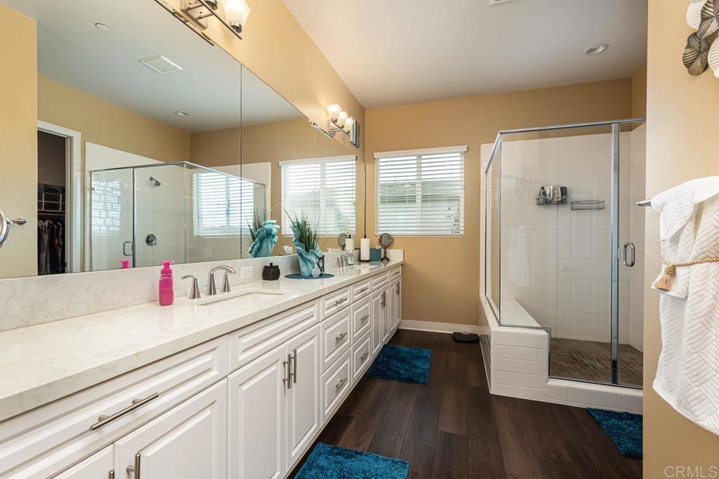 1194 Palomar Circle Escondido, CA 92027 - Photo 14 of 37 a bathroom with a double vanity sink and mirror
