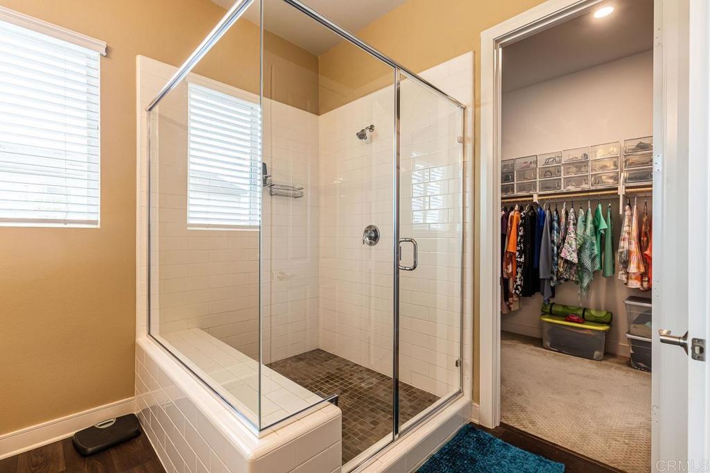 1194 Palomar Circle Escondido, CA 92027 - Photo 15 of 37 a bathroom with a glass shower door and a window