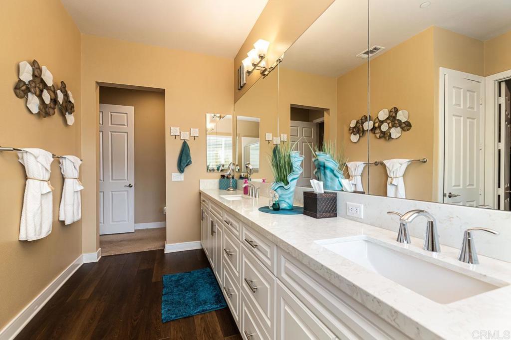 1194 Palomar Circle Escondido, CA 92027 - Photo 16 of 37 a bathroom with a double vanity sink and a mirror