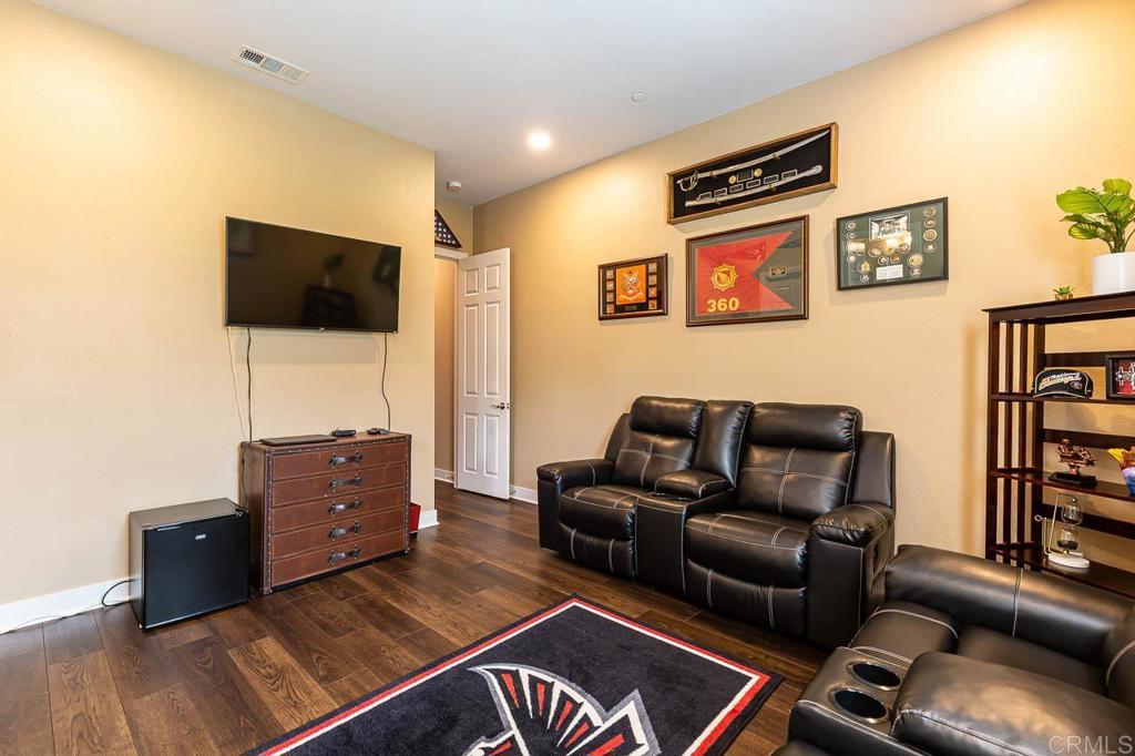 1194 Palomar Circle Escondido, CA 92027 - Photo 18 of 37 a living room with furniture and a flat screen tv