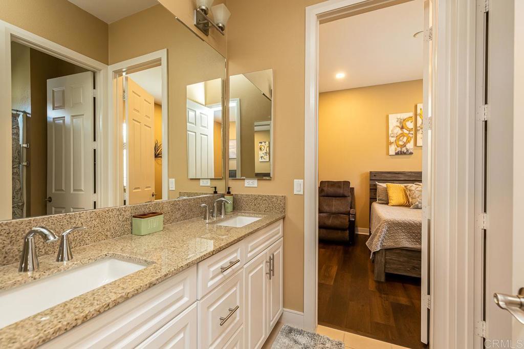 1194 Palomar Circle Escondido, CA 92027 - Photo 22 of 37 a bathroom with a double vanity sink and a mirror