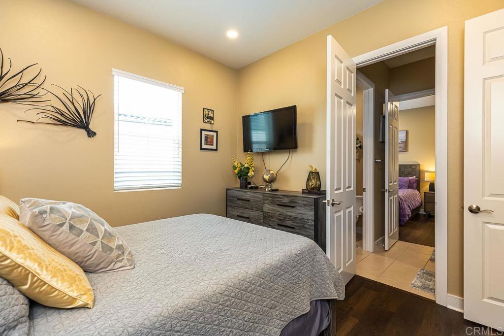 1194 Palomar Circle Escondido, CA 92027 - Photo 24 of 37 a bedroom with a bed and a flat tv screen on wall
