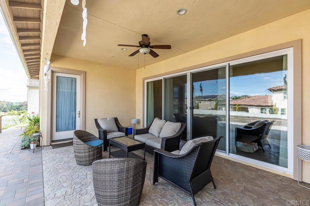 1194 Palomar Circle Escondido, CA 92027 - Photo 27 of 37 a living room with furniture and a floor to ceiling window