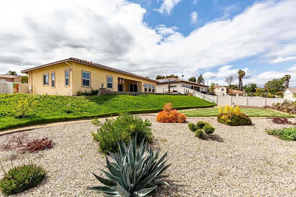 1194 Palomar Circle Escondido, CA 92027 - Photo 33 of 37 a view of a house with a yard and potted plants