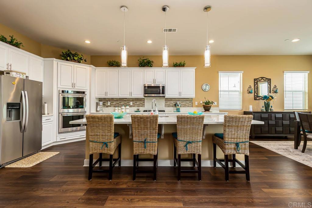 1194 Palomar Circle Escondido, CA 92027 - Photo 4 of 37 a large kitchen with a table and chairs