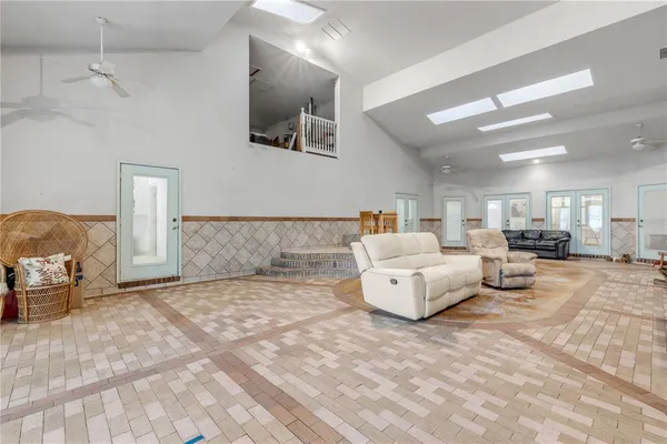 a large white kitchen with a sink and cabinets