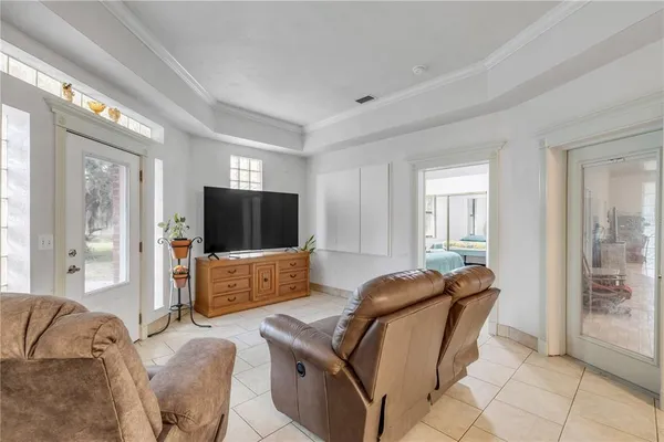 a living room with furniture and a view of kitchen