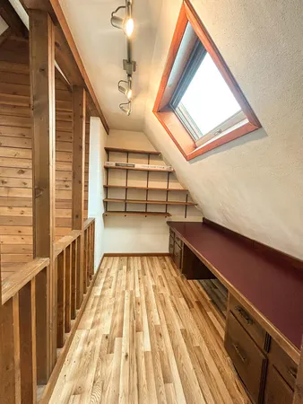 a view of entryway and hall with wooden floor