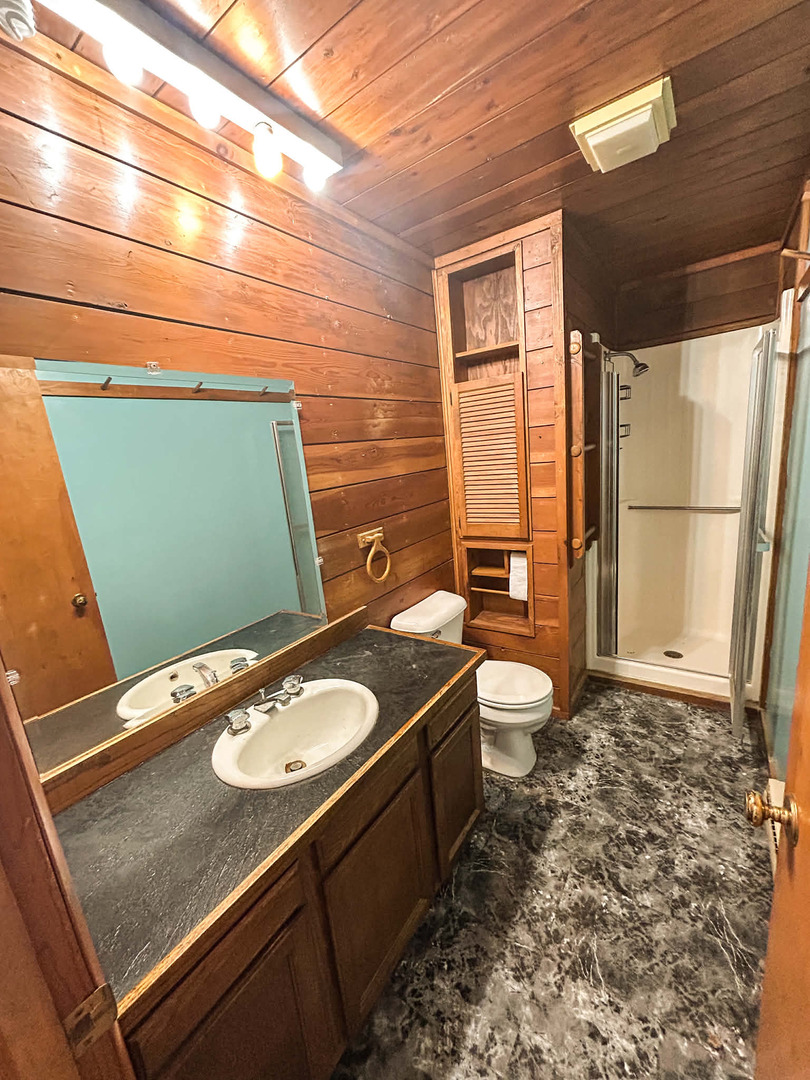2211 613th Avenue Sabula, IA 52070 - Photo 24 of 45 a bathroom with a granite countertop sink toilet and shower