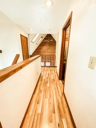 a view of a hallway with wooden floor