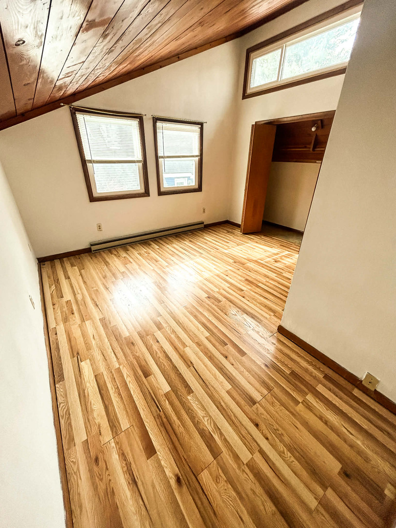 2211 613th Avenue Sabula, IA 52070 - Photo 27 of 45 a view of an empty room with wooden floor and a window