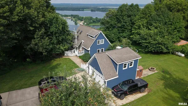 an aerial view of a house with garden space and street view