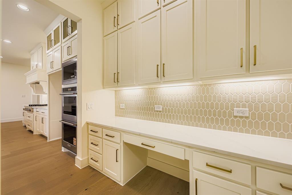 1906 M3 Ranch Road Mansfield, TX 76063 - Photo 13 of 29 Kitchen featuring tasteful backsplash, stainless steel appliances, glass insert cabinets, recessed lighting, and light wood-type flooring