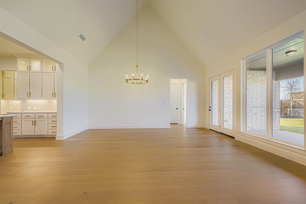 1906 M3 Ranch Road Mansfield, TX 76063 - Photo 8 of 29 Unfurnished dining area with high vaulted ceiling, a chandelier, and light wood finished floors