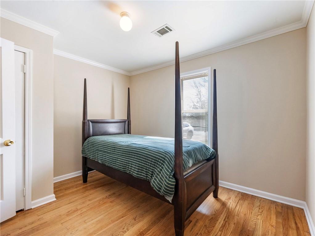 1686 Shoal Creek Road Monroe, GA 30656 - Photo 27 of 50 a bedroom with a bed and wooden floor
