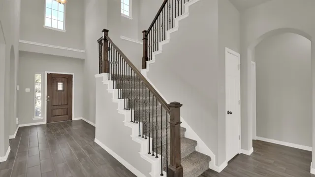 a view of entryway with wooden floor and stairs