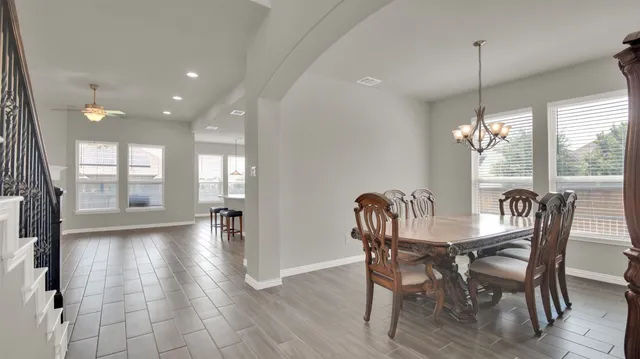 a kitchen with a refrigerator and a stove top oven
