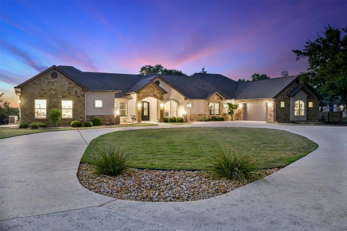 Exterior lighting adds so much ambience as you pull up to this custom home.