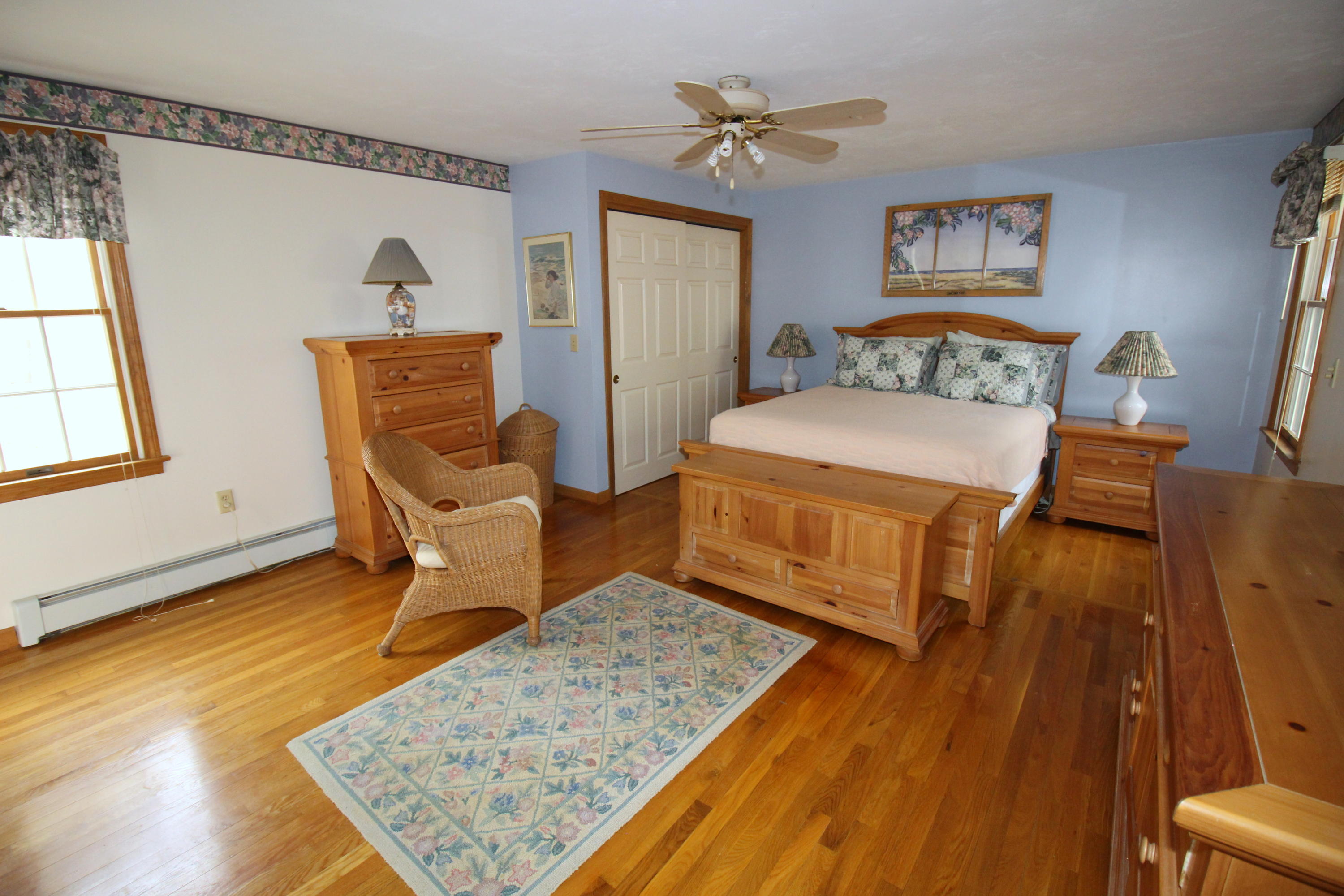 9 Gates Path Dennis, MA 02638 - Photo 15 of 20 a bedroom with a bed and wooden floor